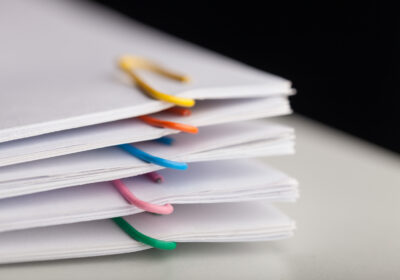 File folders with documents and bright paperclips