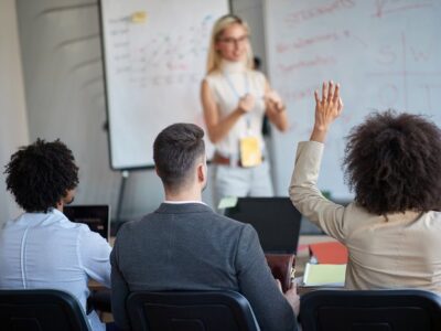 staff-development-training-woman-raising-ha.max-1028x464